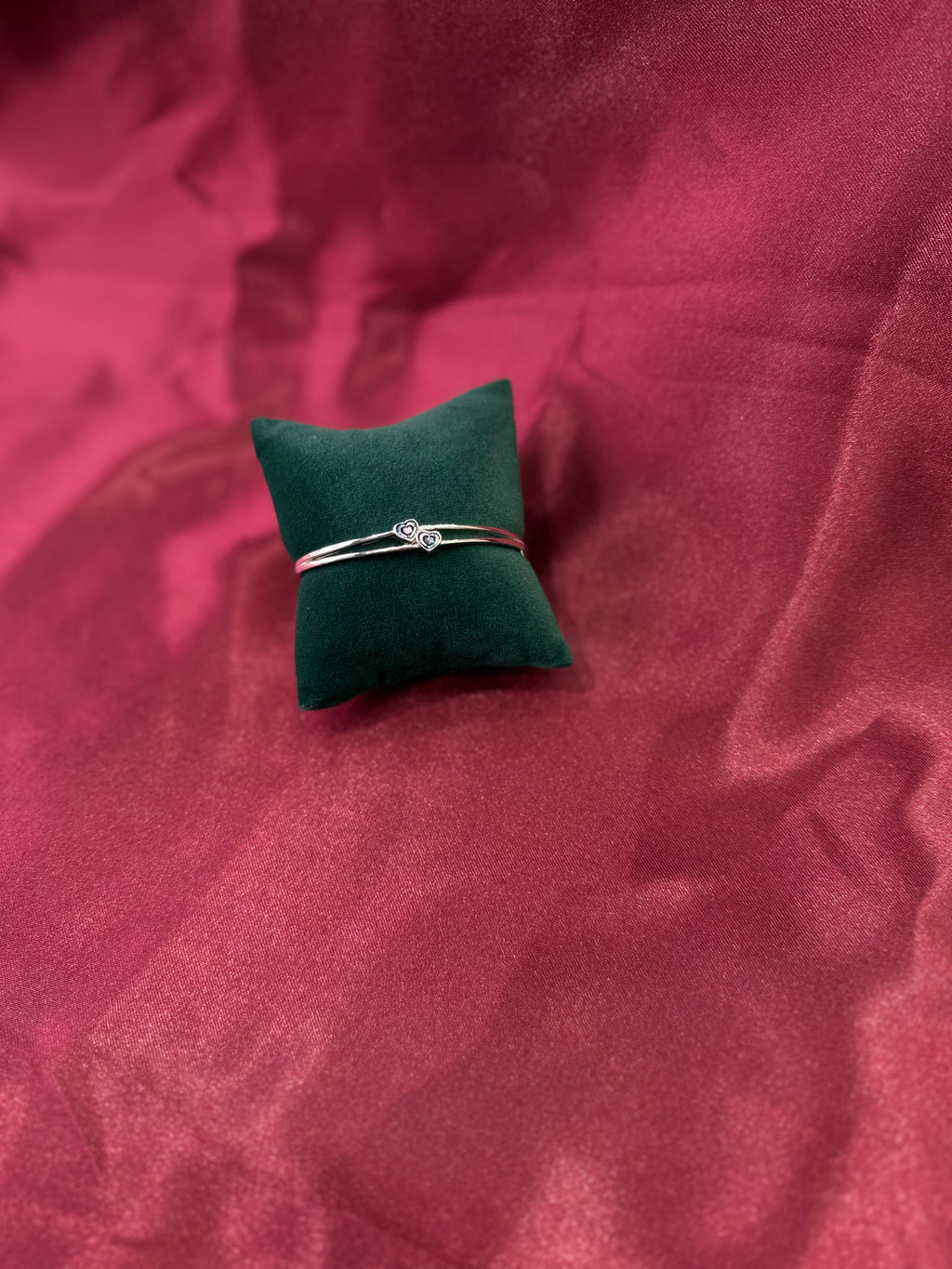 Fancy silver bangle with tiny twin hearts