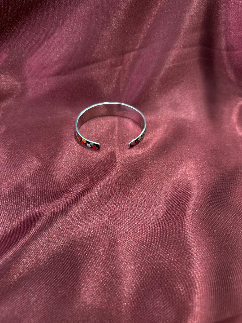 Fancy silver bangle with vibrant star & flower pattern