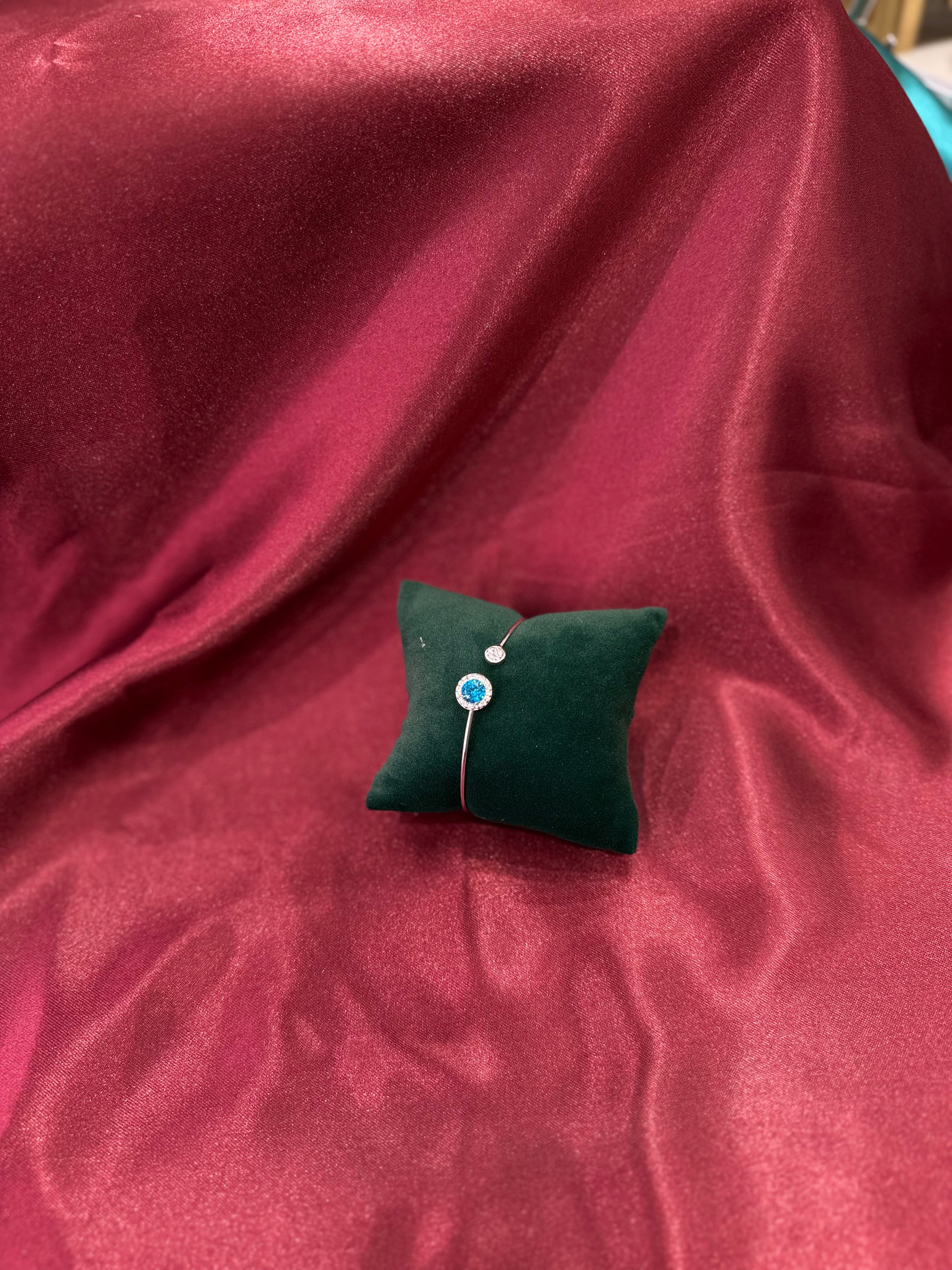 Sleek silver diamond with CZ diamond with blue stone