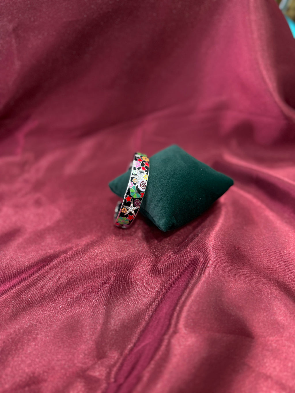 Fancy silver bangle with vibrant star & flower pattern