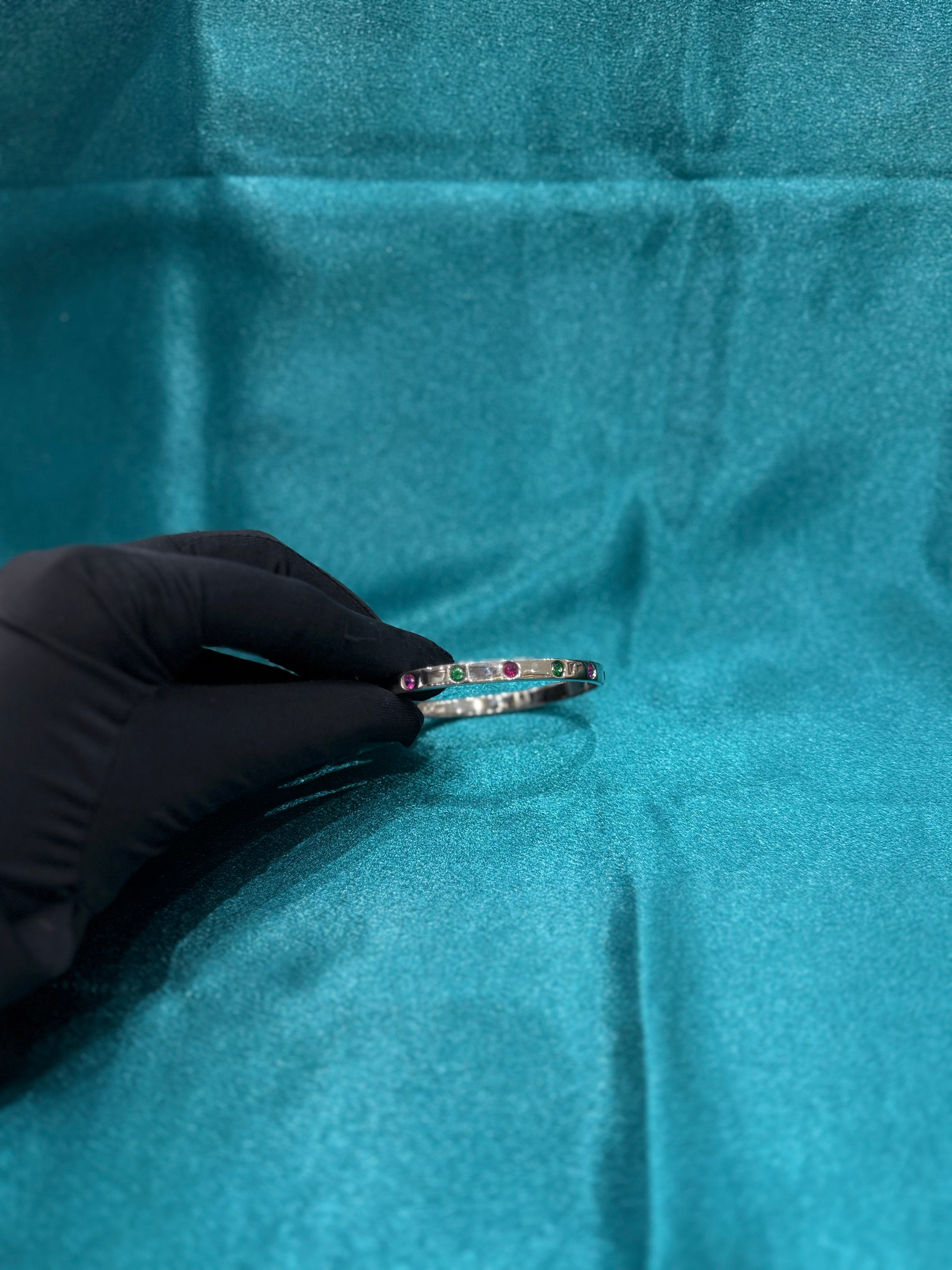Fancy silver openable bangle with pink and green stone