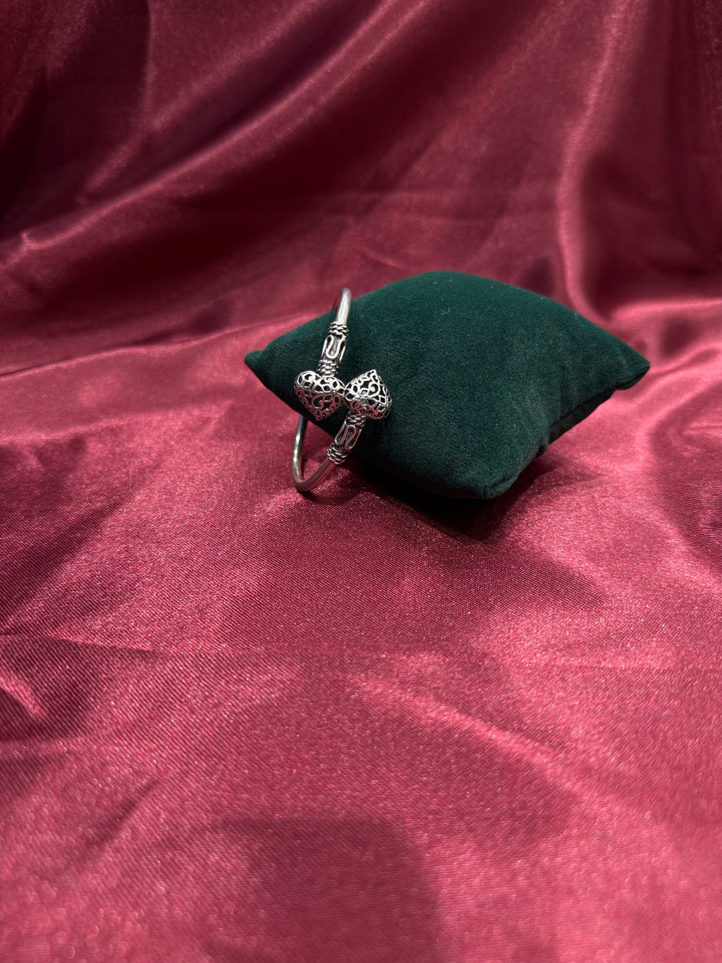 Fancy silver antique style open bangle with hearts at end