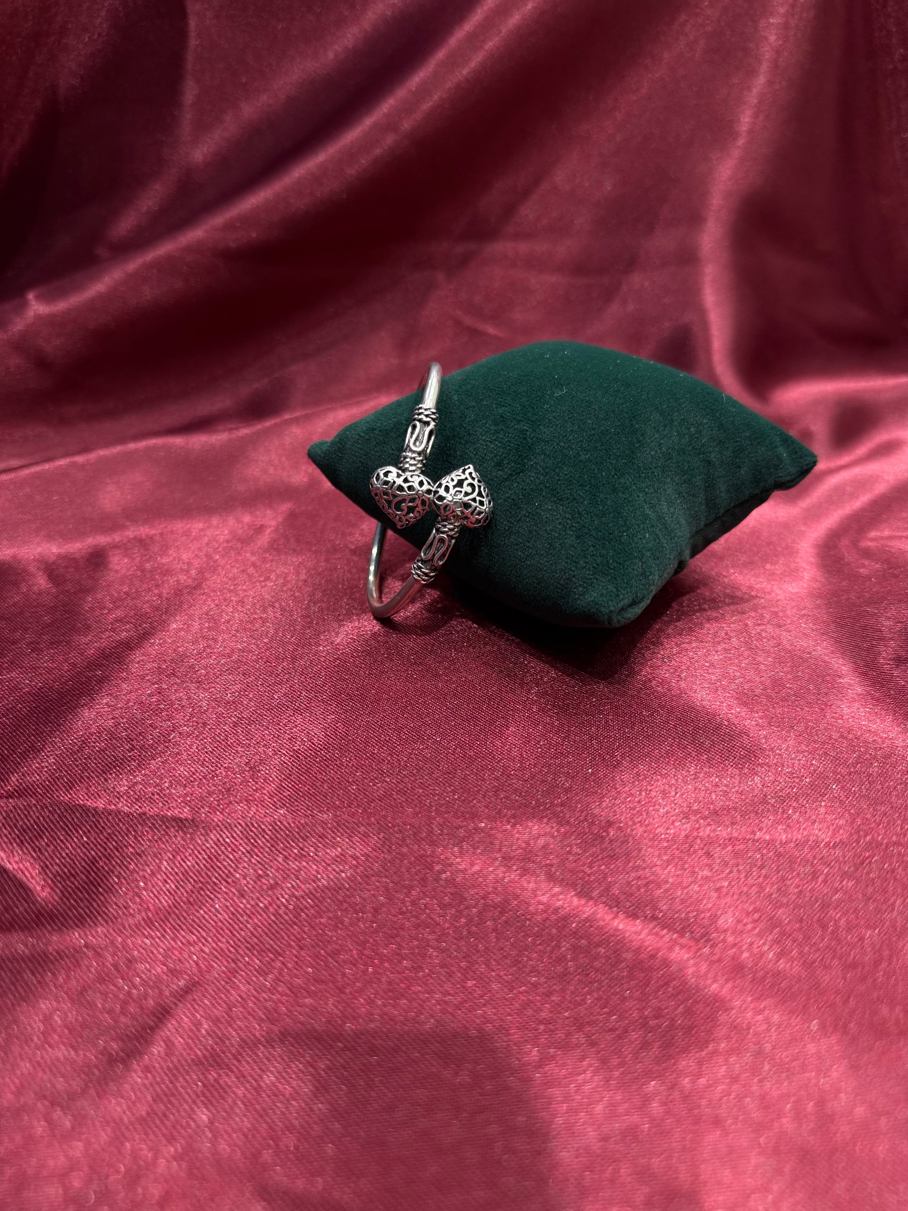 Fancy silver antique style open bangle with hearts at end