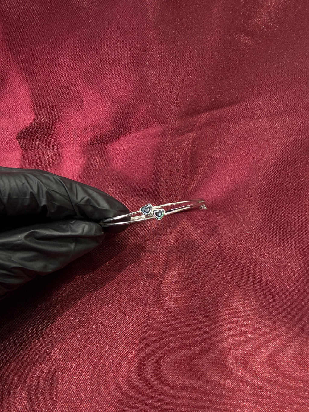 Fancy silver bangle with tiny twin hearts