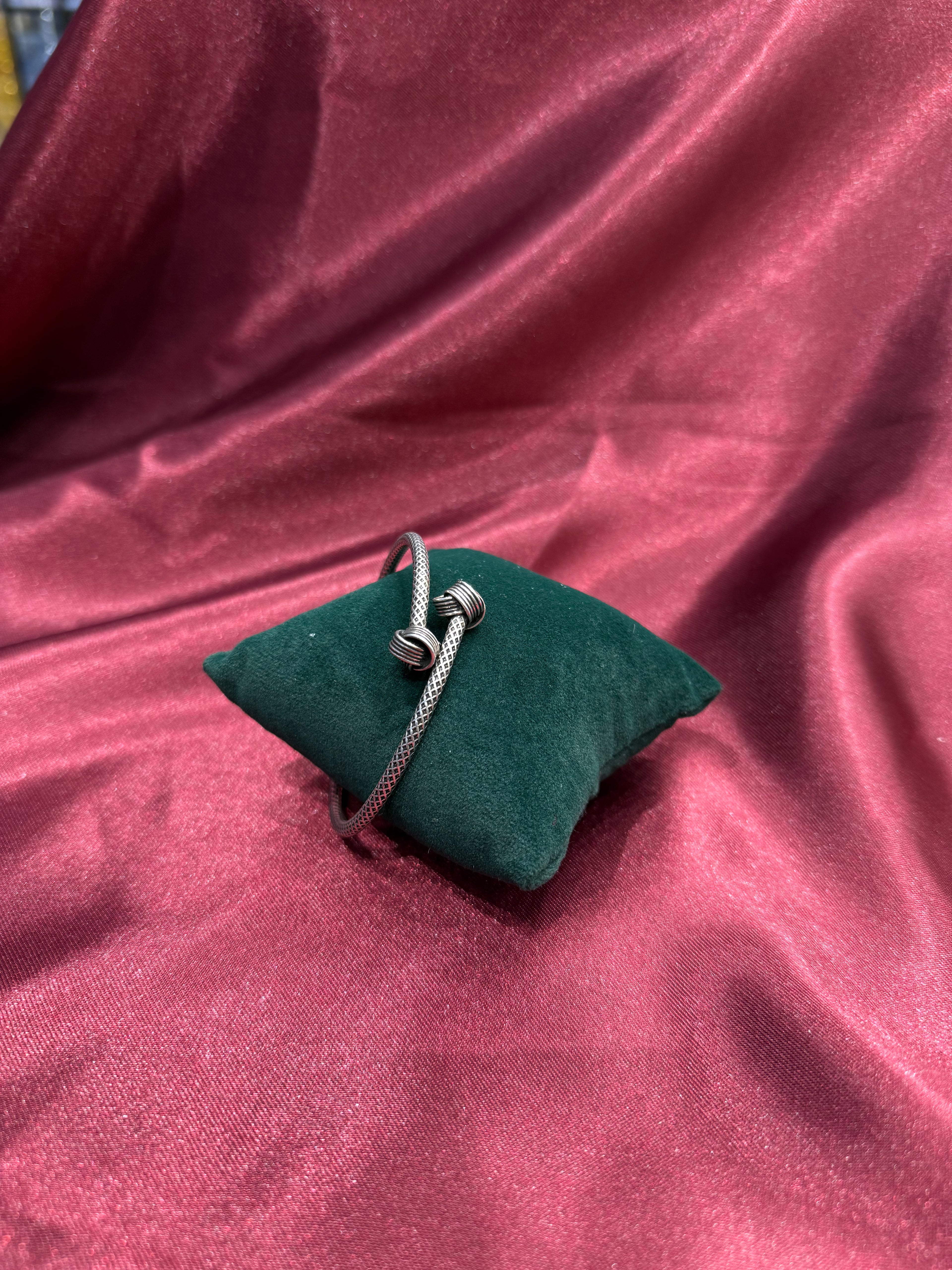 Fancy silver antique style open bangle with knot design