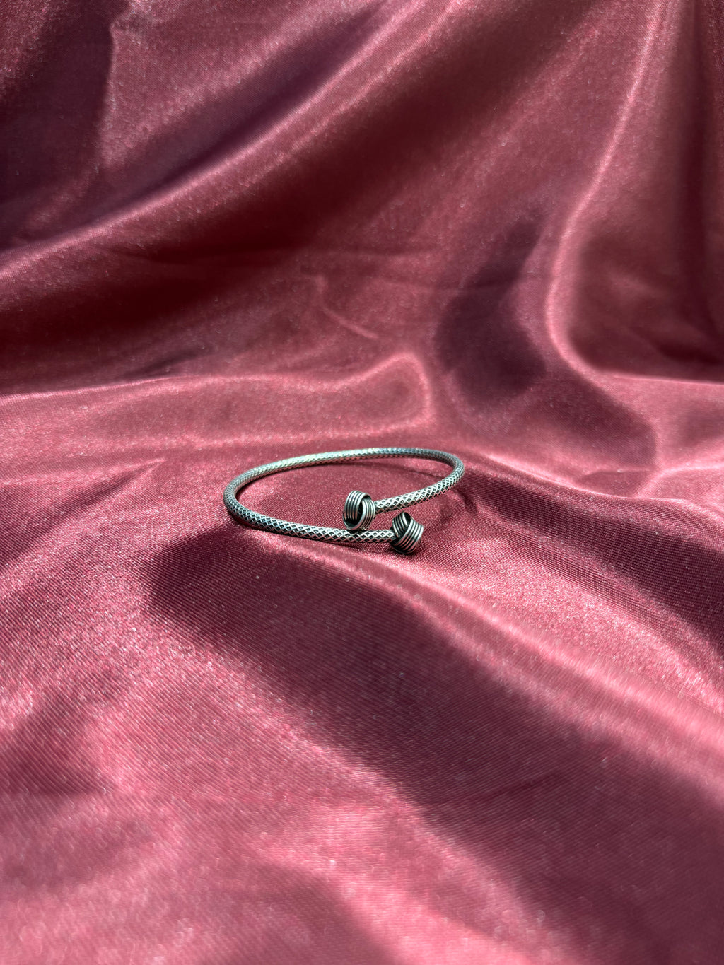 Fancy silver antique style open bangle with knot design