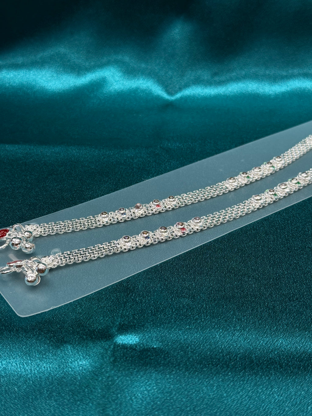 Traditional silver anklet with floral pattern and stones