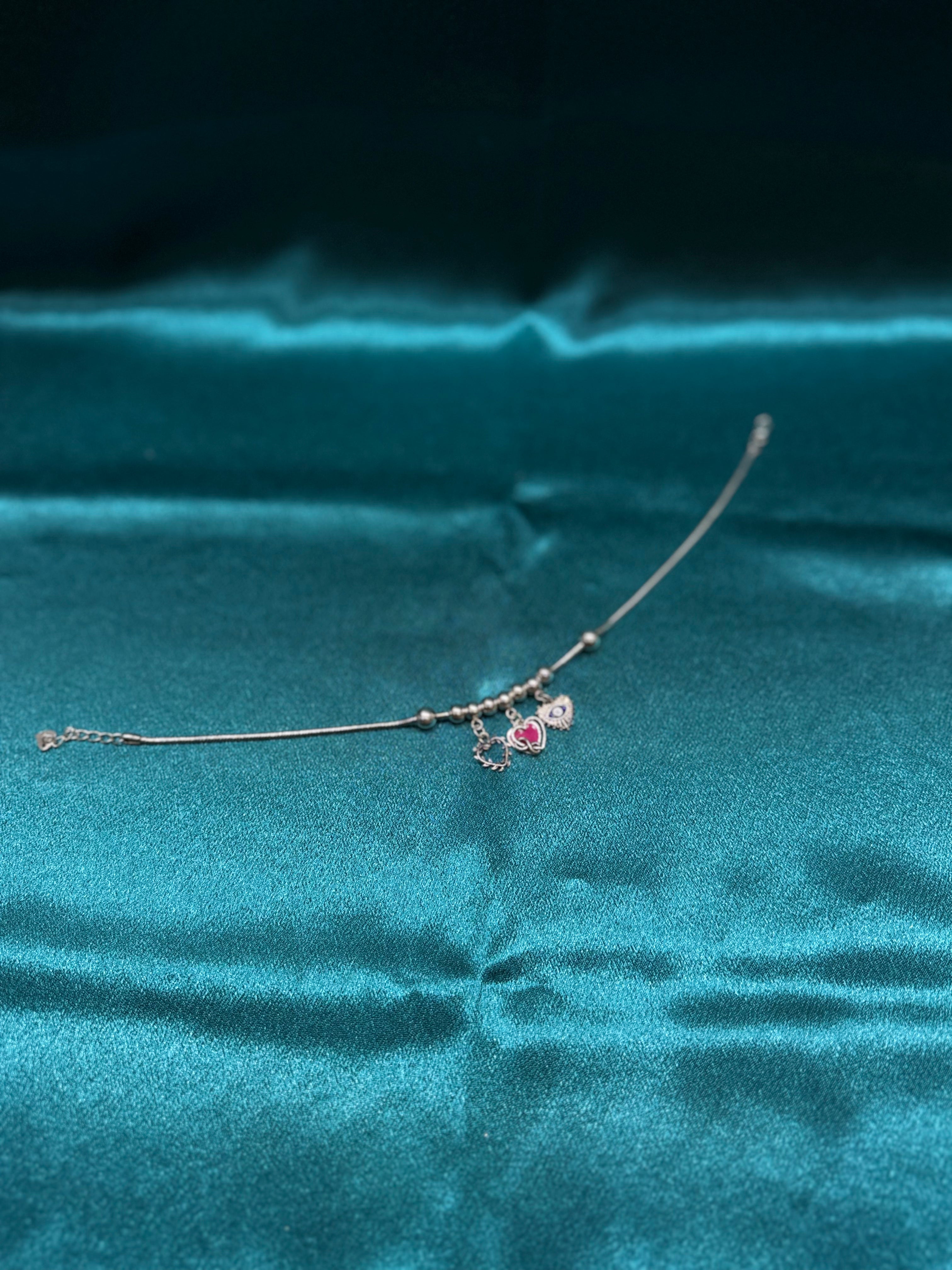 Single fancy silver anklet with hanging hearts and evil eye charm