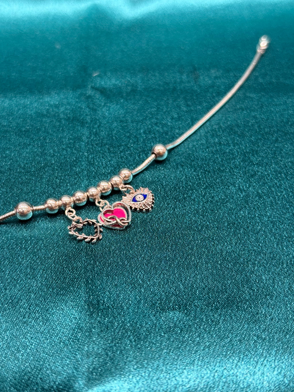 Single fancy silver anklet with hanging hearts and evil eye charm