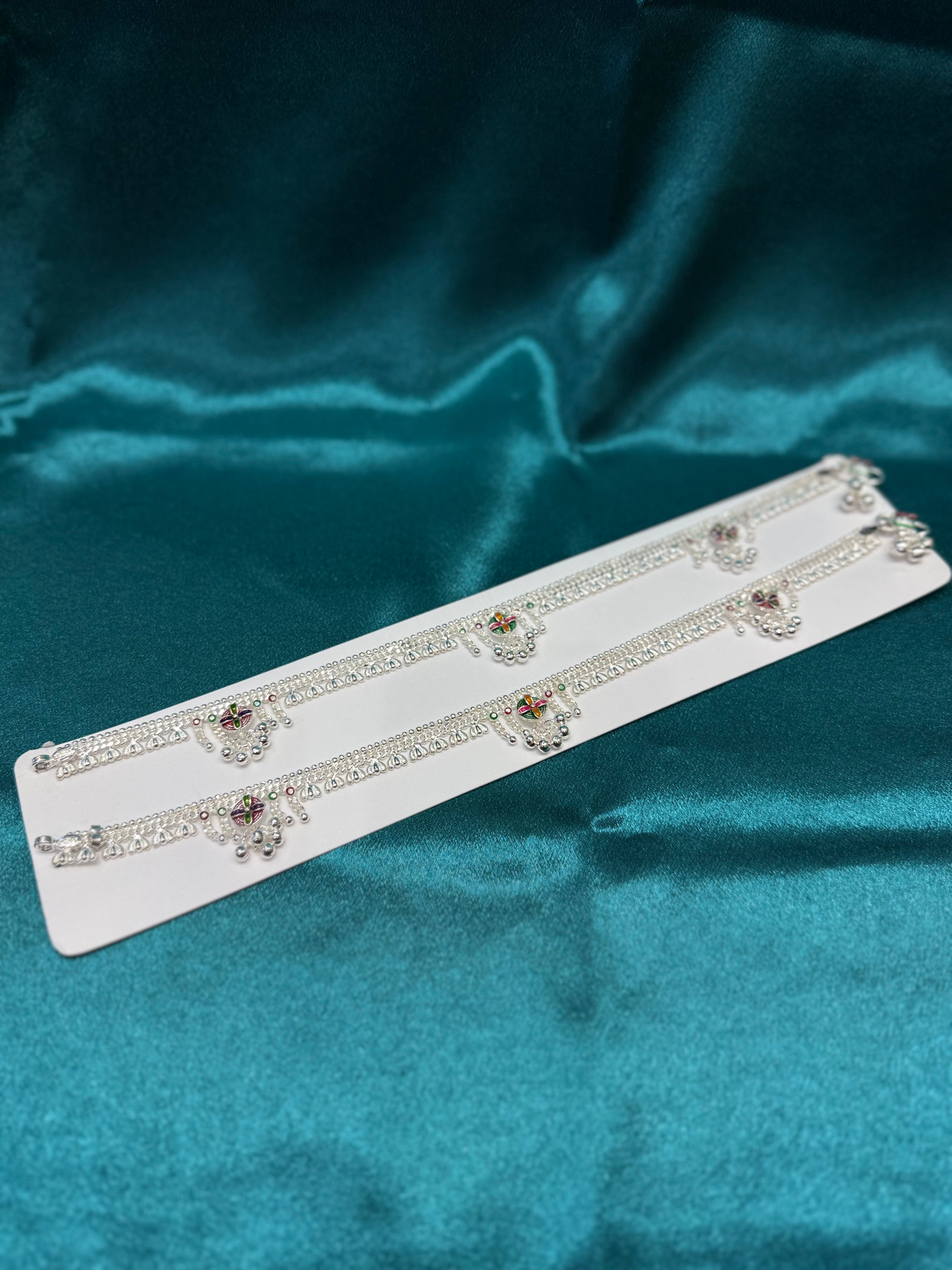 Traditional silver anklet with flower pattern and bells hanging