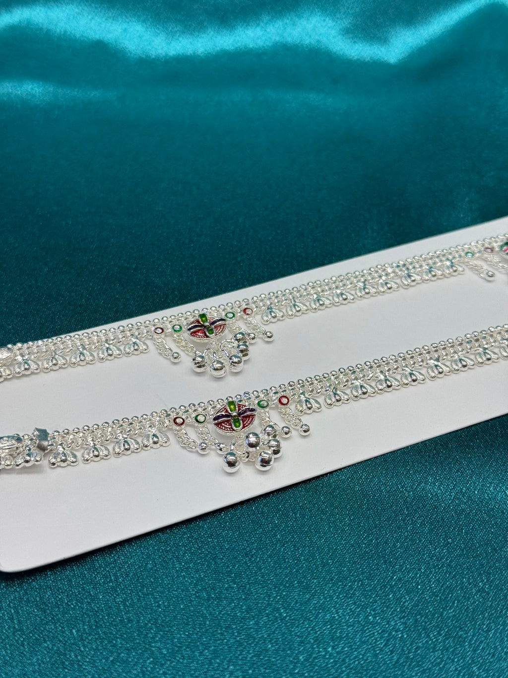 Traditional silver anklet with flower pattern and bells hanging