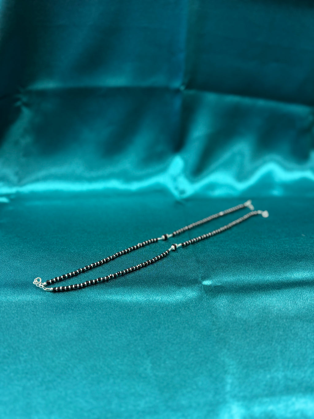 Fancy silver anklets with black beads