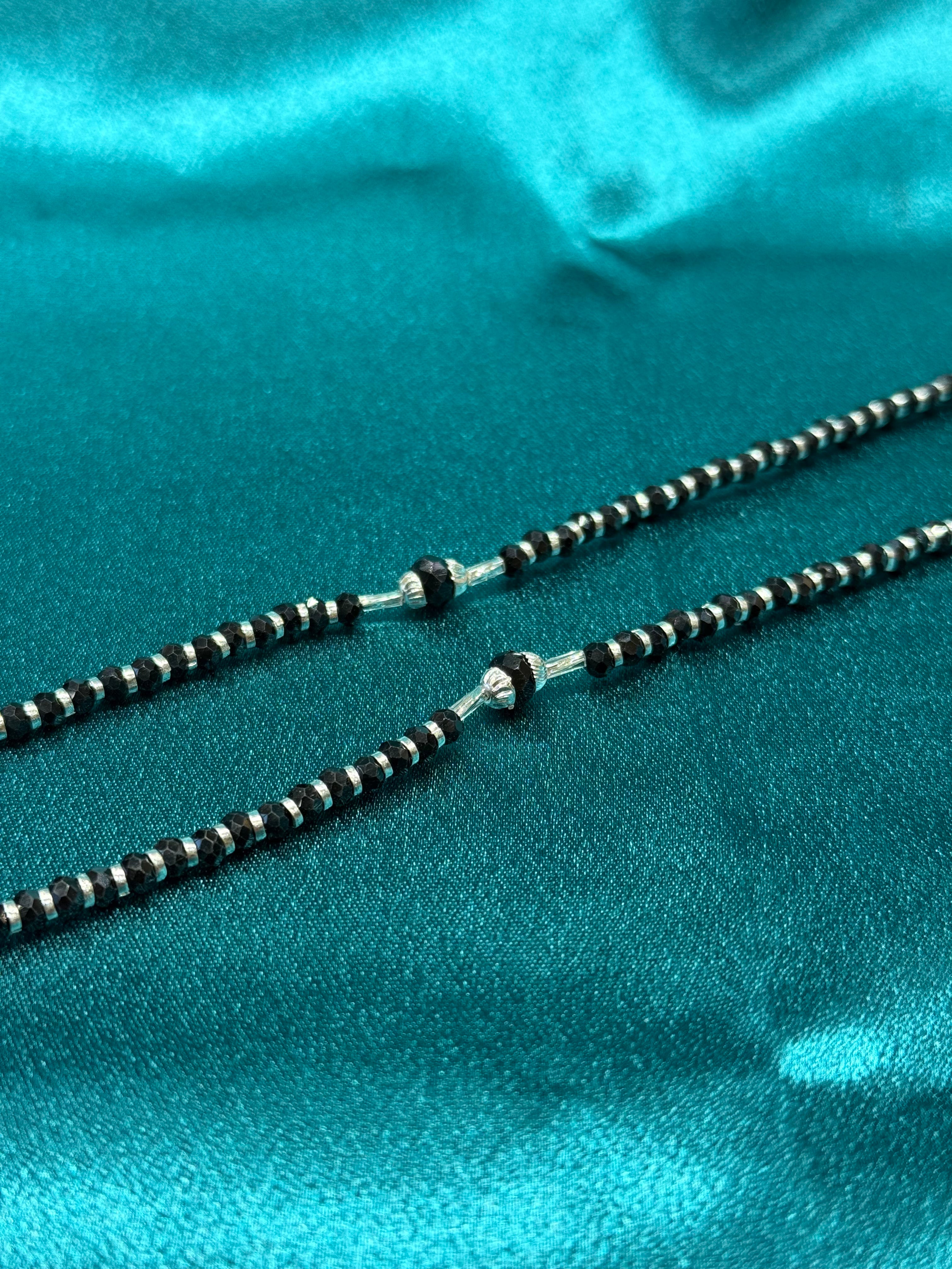 Fancy silver anklets with black beads