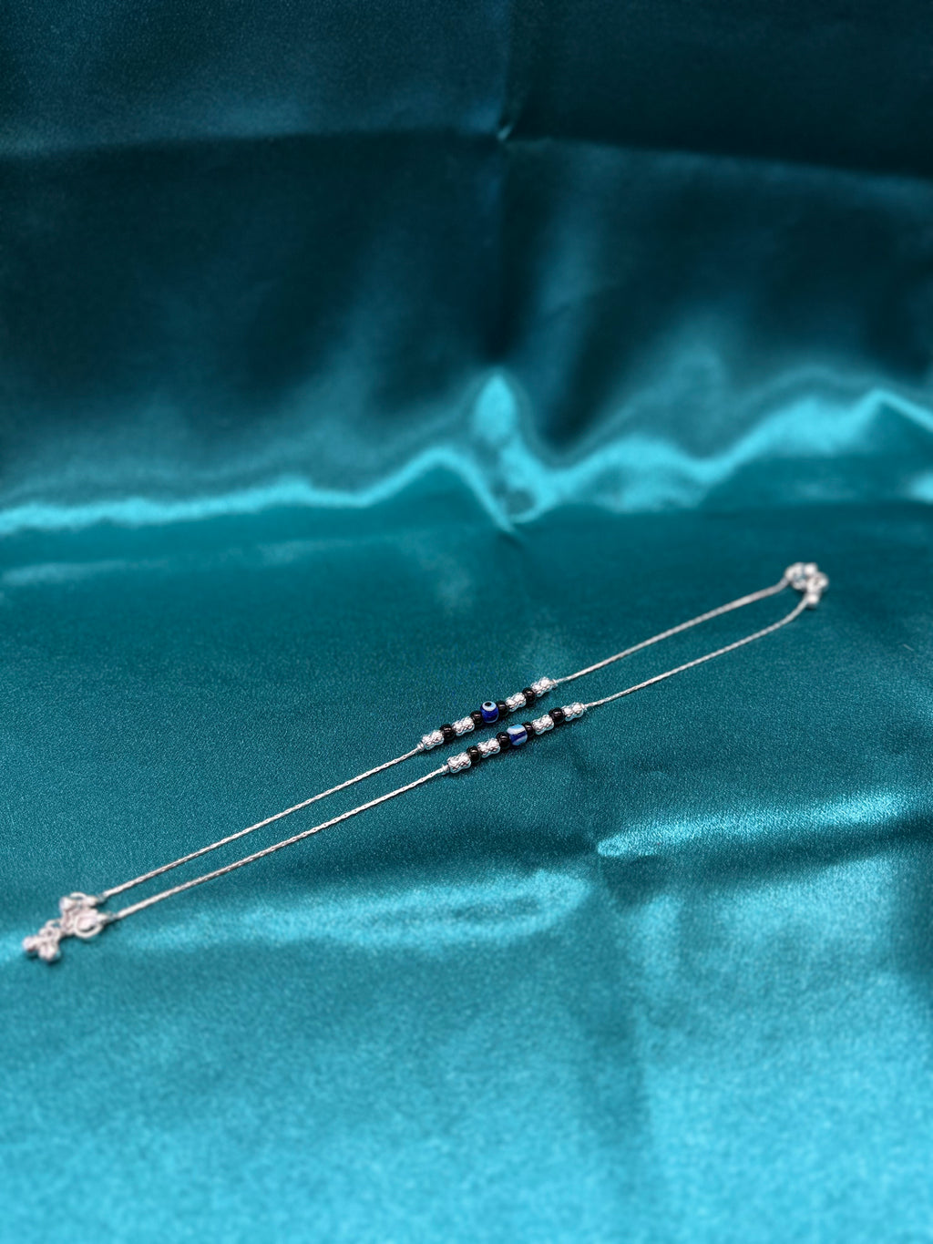 Fancy silver anklet with evil eye and black beads