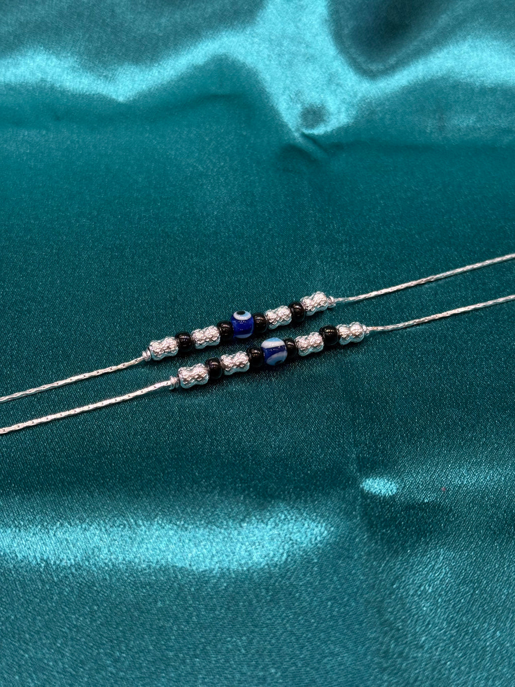 Fancy silver anklet with evil eye and black beads