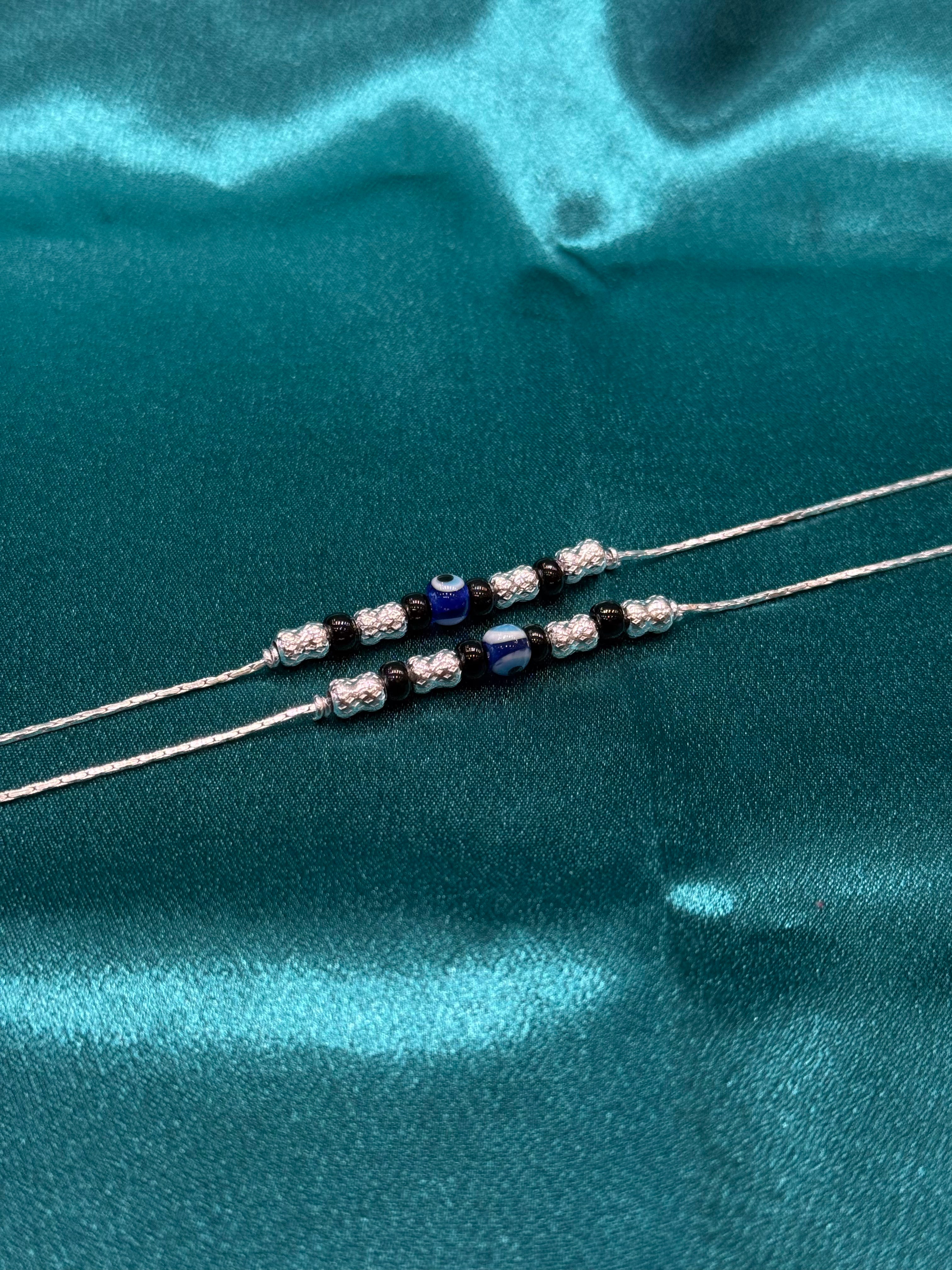 Fancy silver anklet with evil eye and black beads