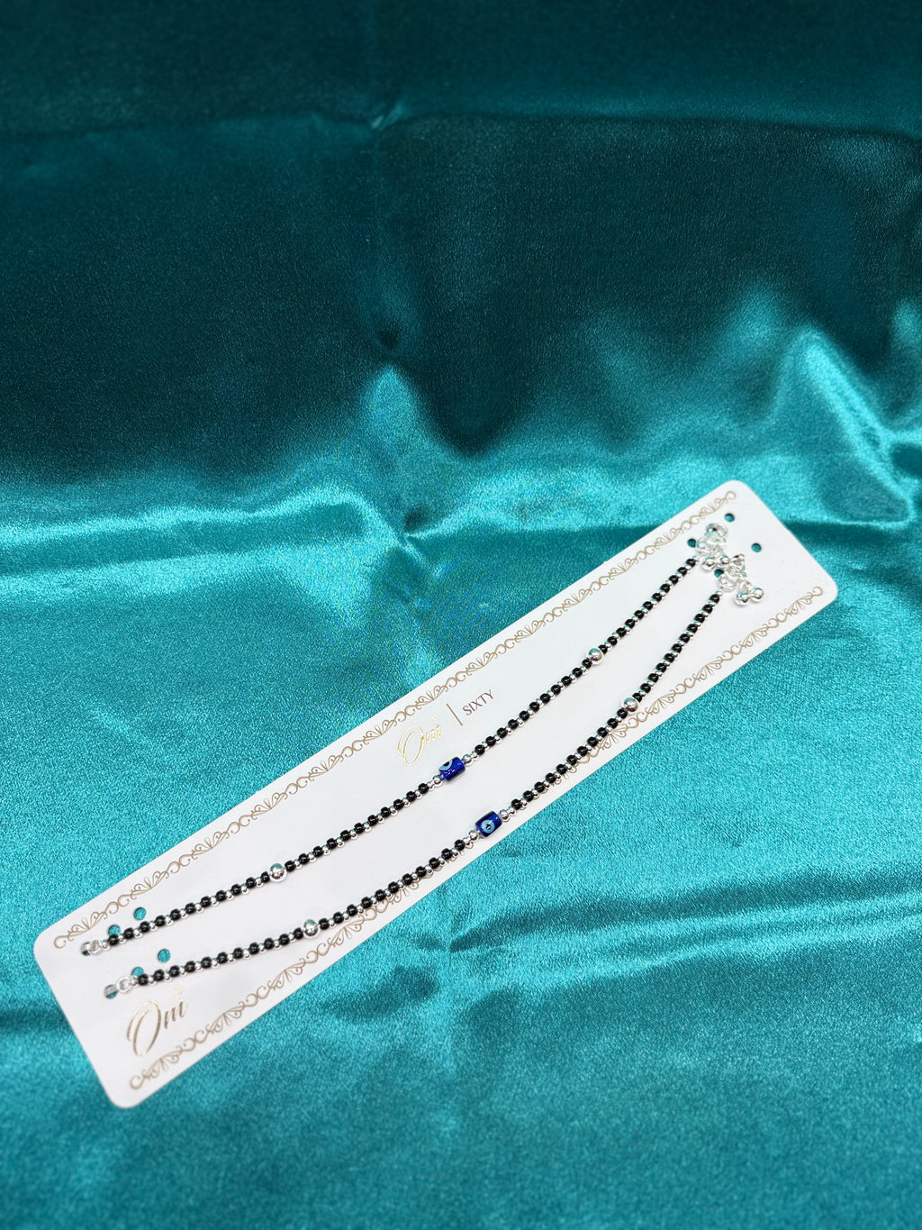 Fancy silver anklet with black, silver and blue evil eye
