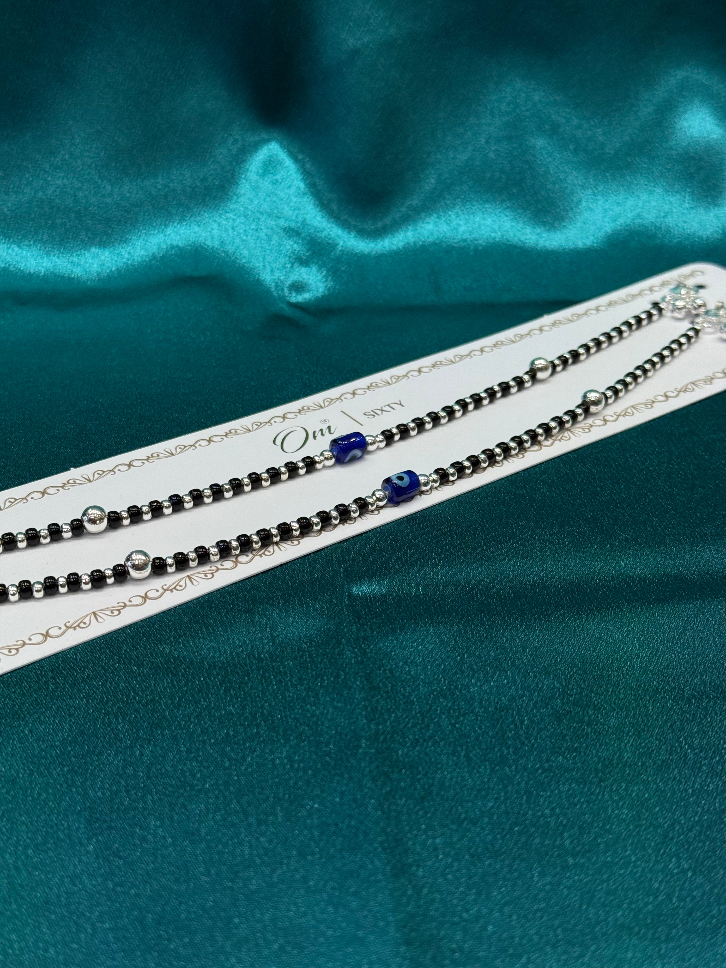 Fancy silver anklet with black, silver and blue evil eye