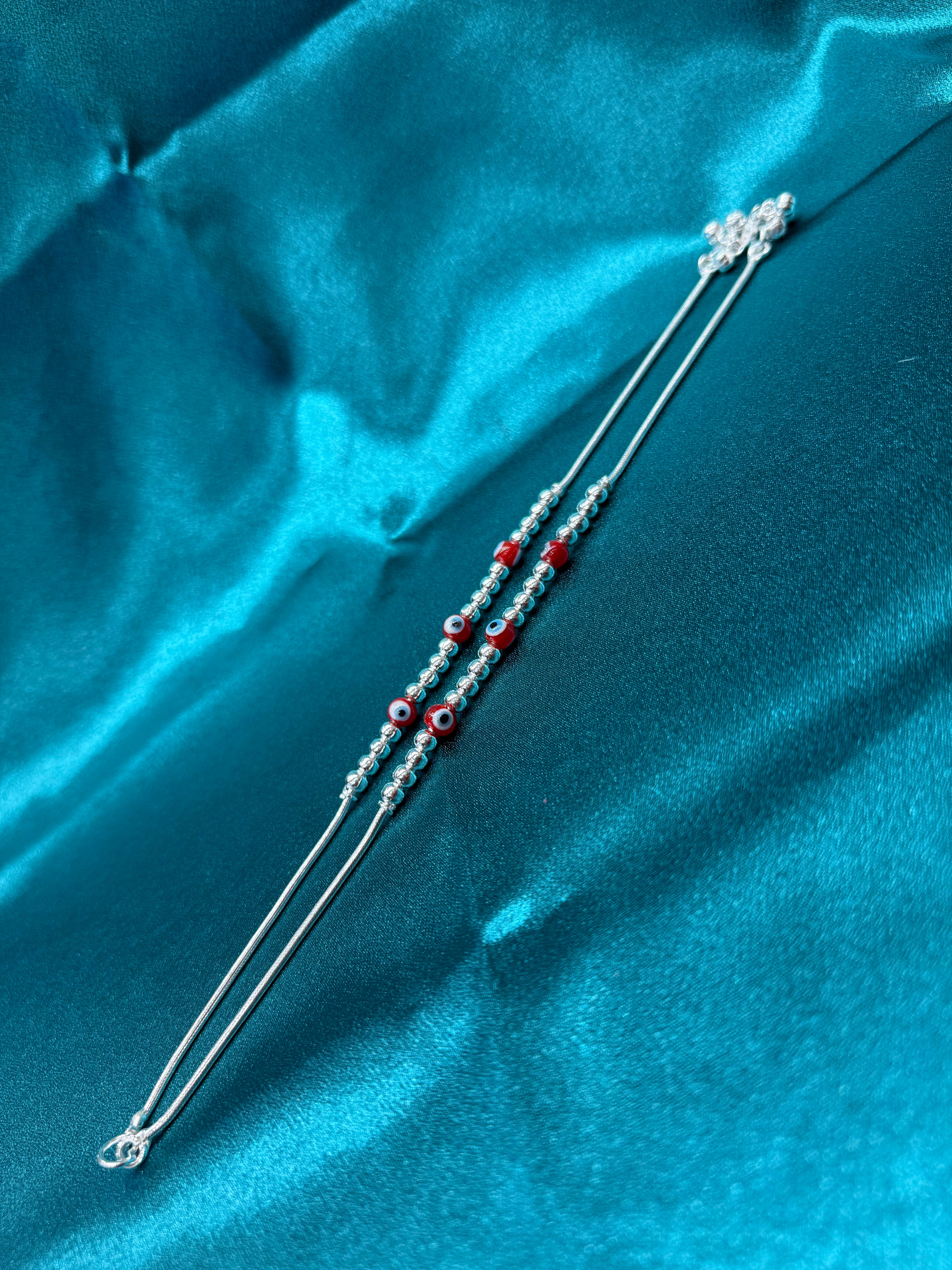 Fancy silver anklet with red evil eye