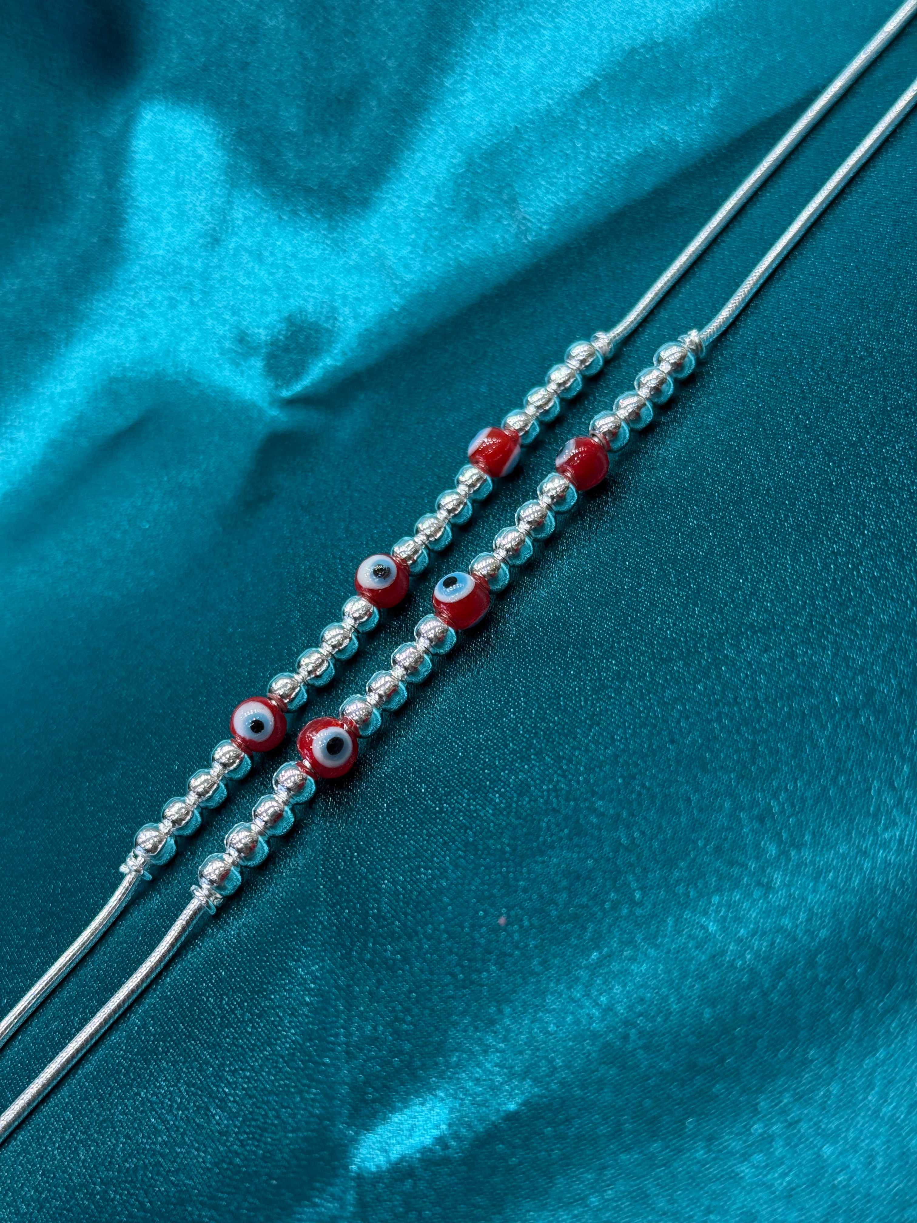 Fancy silver anklet with red evil eye
