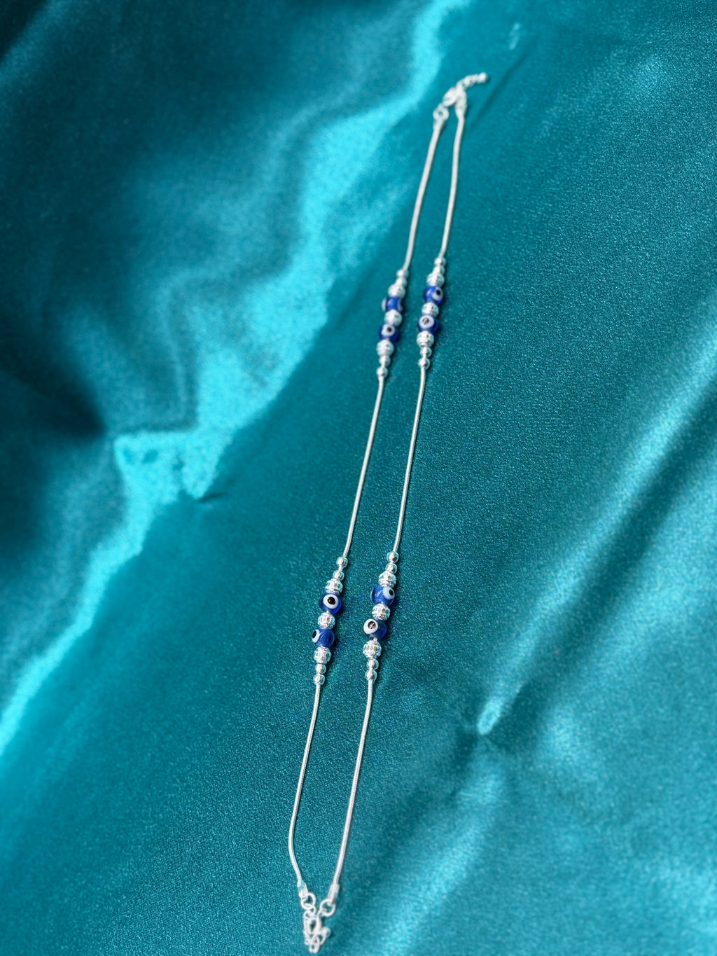 Fancy silver anklet with blue evil eye