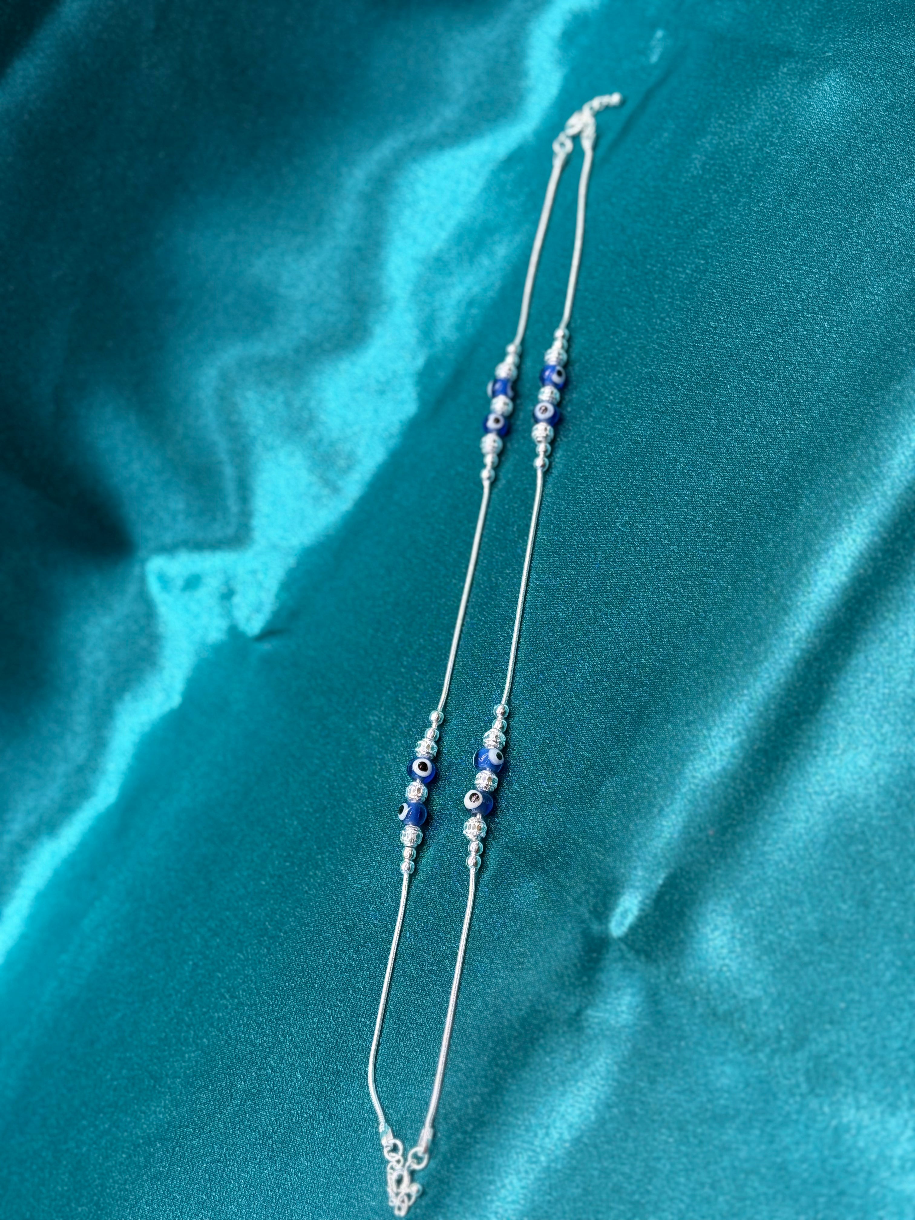 Fancy silver anklet with blue evil eye