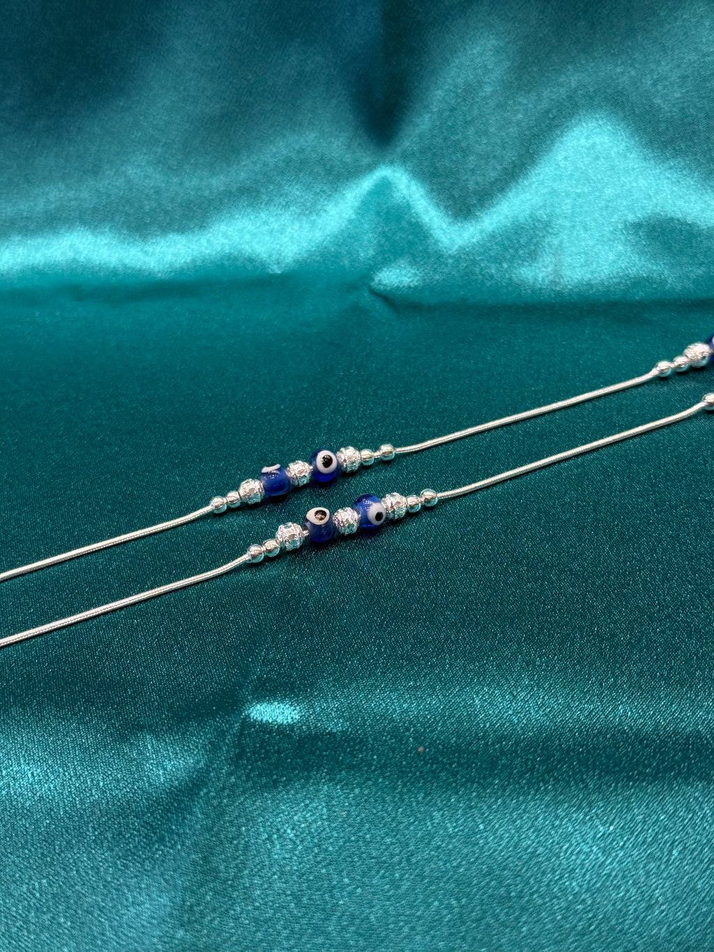 Fancy silver anklet with blue evil eye