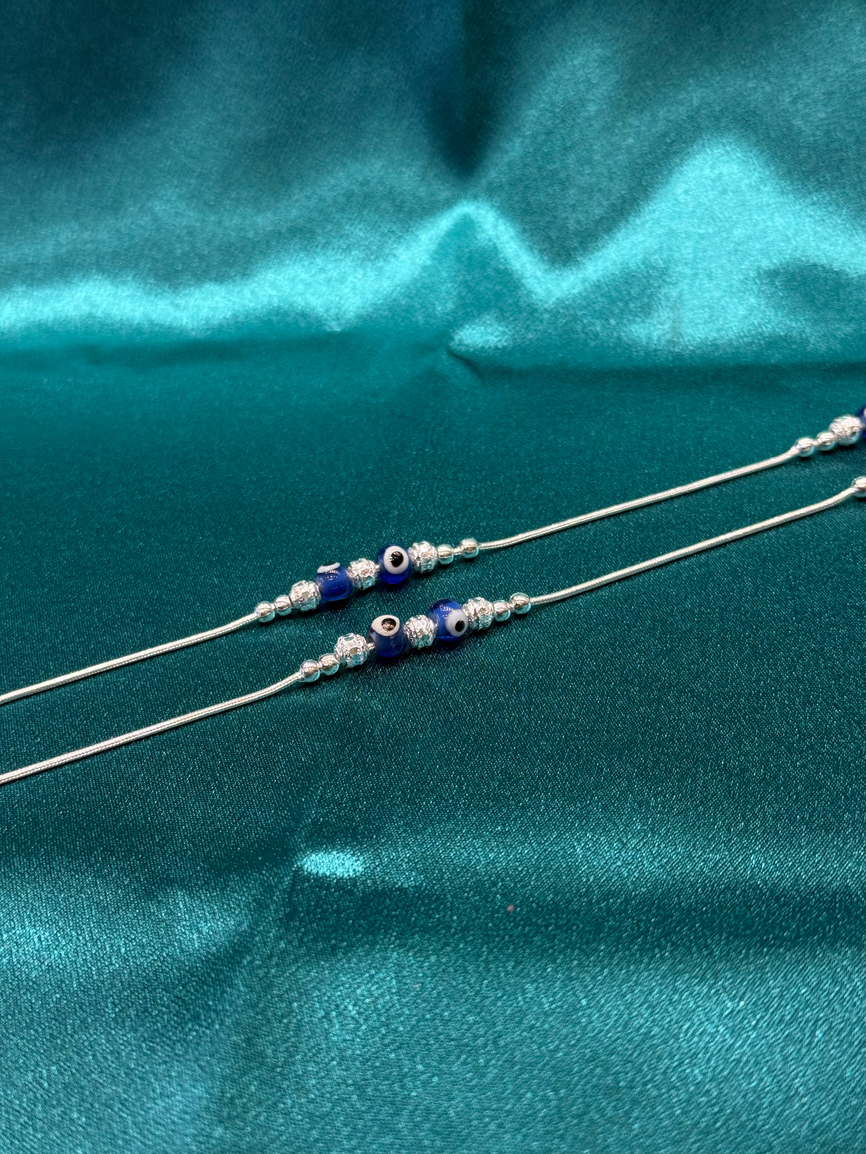Fancy silver anklet with blue evil eye
