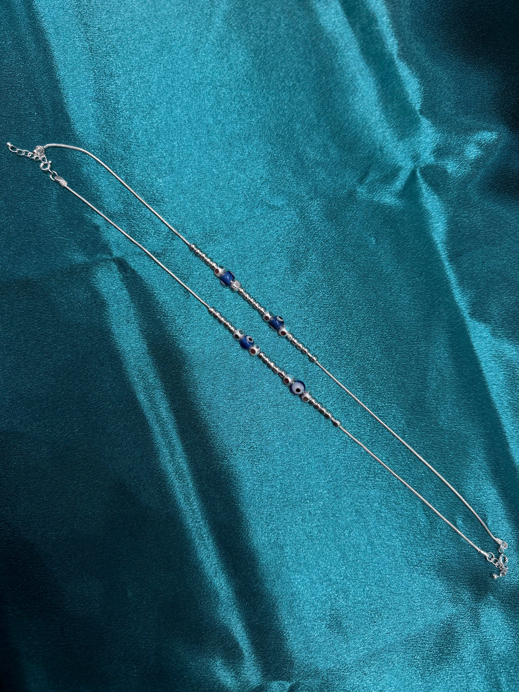 Fancy silver anklet with silver and blue evil eye round beads