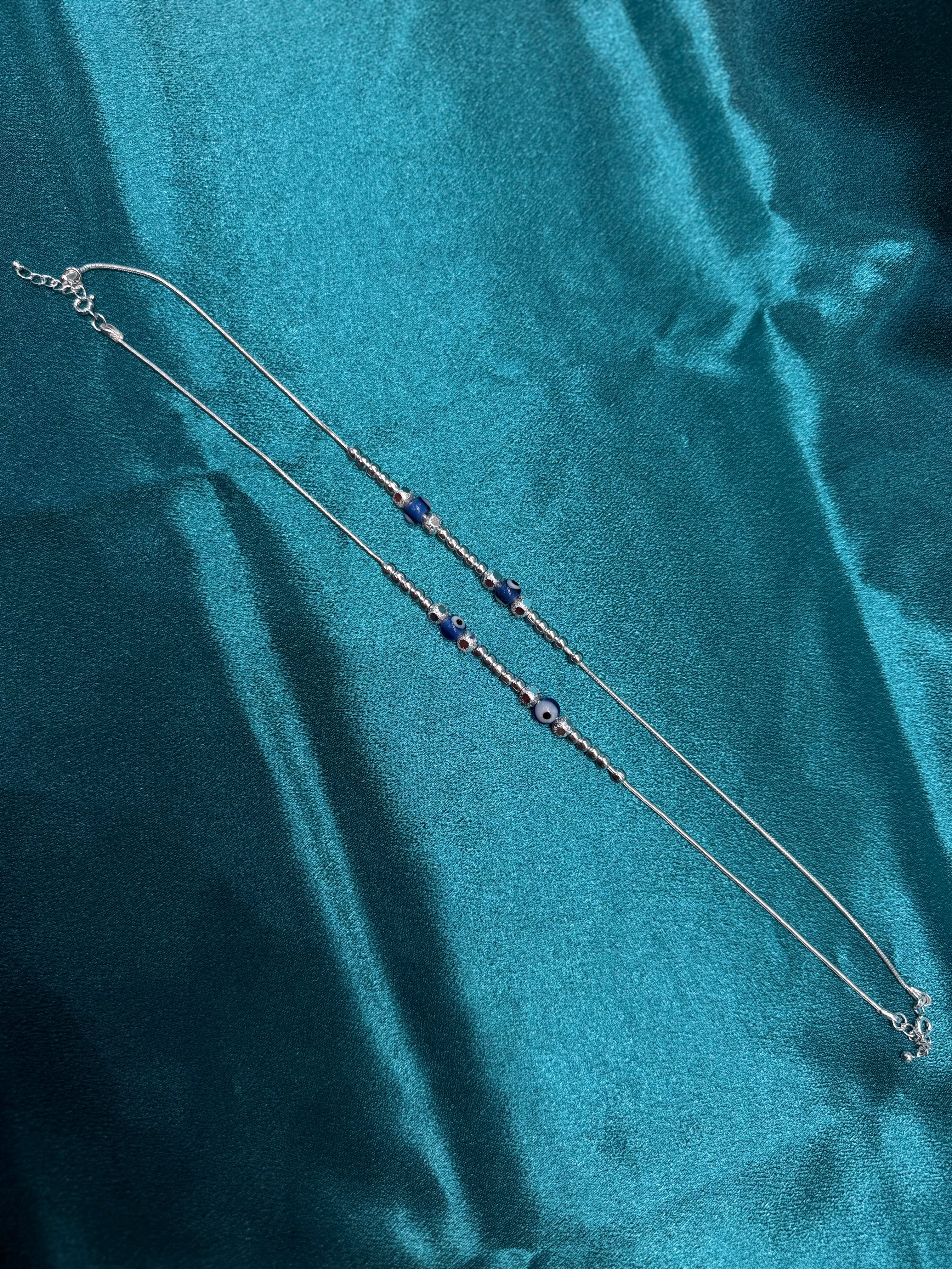 Fancy silver anklet with silver and blue evil eye round beads
