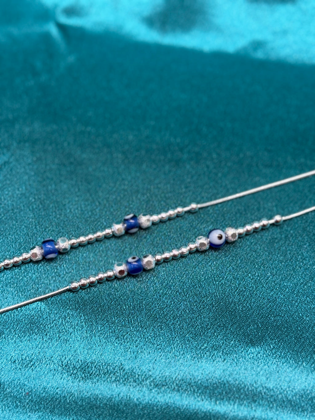 Fancy silver anklet with silver and blue evil eye round beads