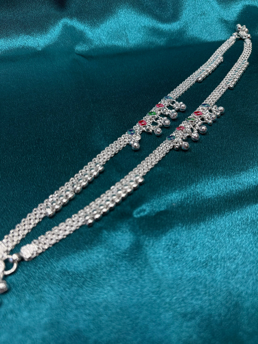 Traditional style silver anklets with hanging bells in middle