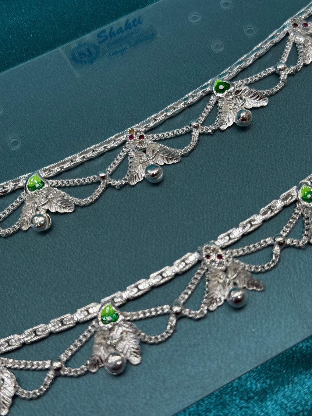 Traditional silver anklet with leaf and bell hanging