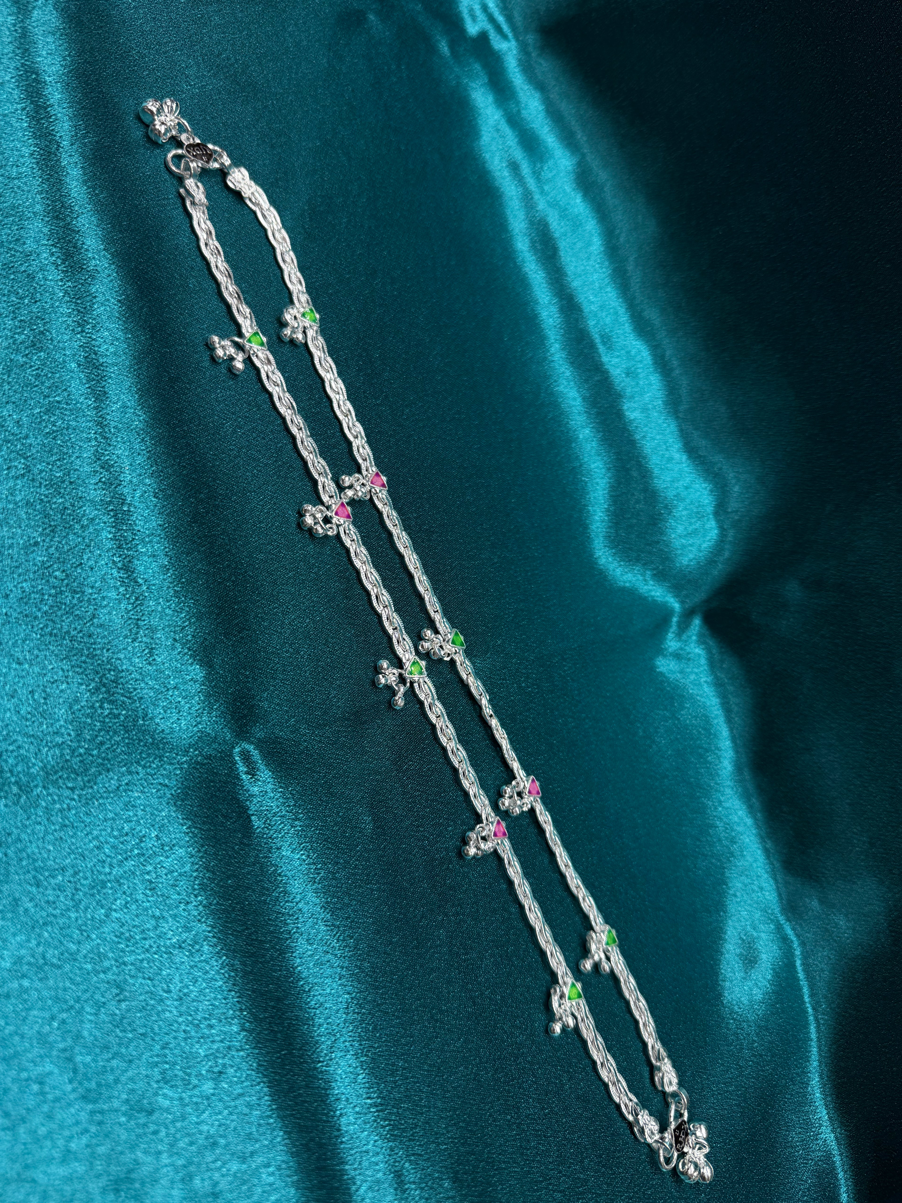 Traditional style silver anklets with hanging bell charm with pink and green triangle