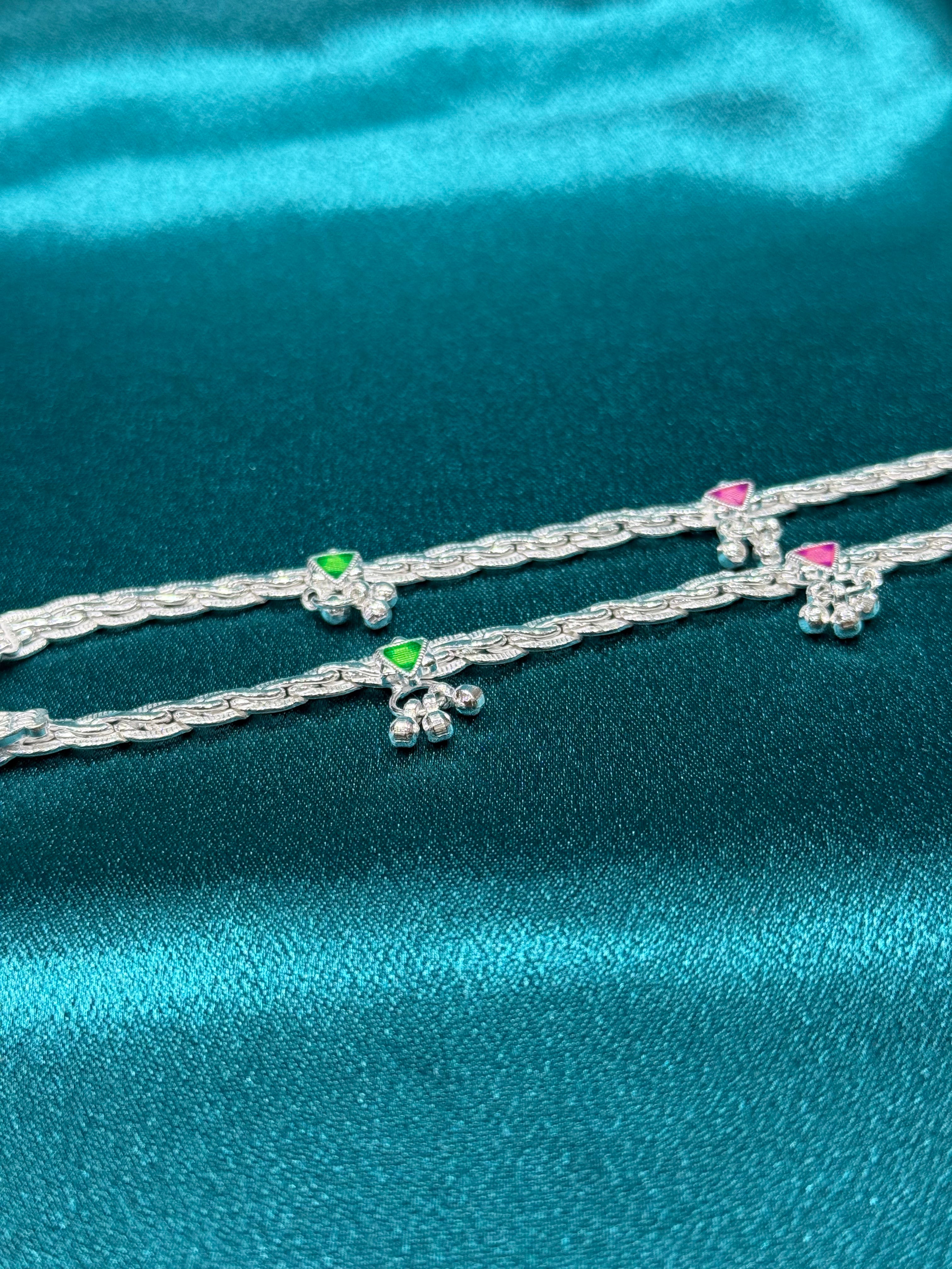 Traditional style silver anklets with hanging bell charm with pink and green triangle